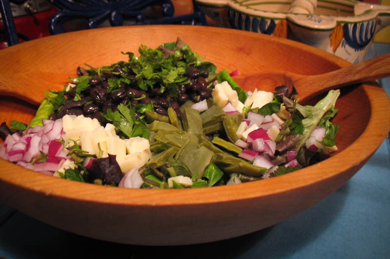 Rancho Gordo | Midnight Black Bean in a salad with black beans and cheese, showcasing its creamy texture and versatility.