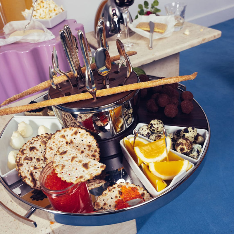 Christofle | MOOD Party 24 Pieces displayed on a lazy Susan with appetizers, featuring silverware for six guests, embodies effortless, sophisticated entertaining from Athens Cooks.