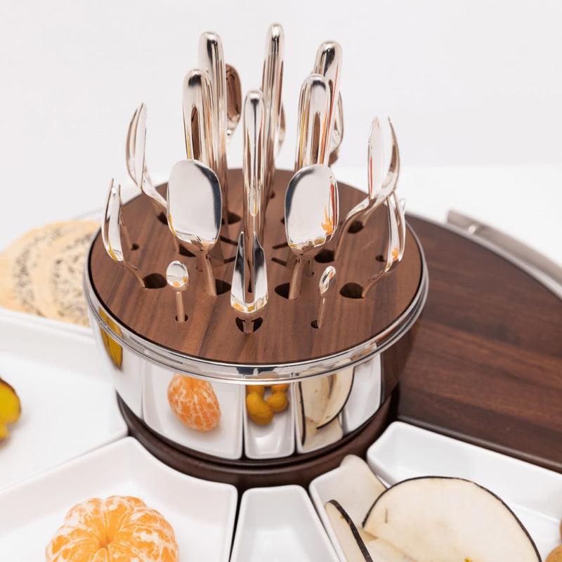 Christofle | MOOD Party 24 Pieces set with white ceramic dishes and a wooden-and-stainless-steel caddy, featuring polished metal utensils for elegant entertaining.