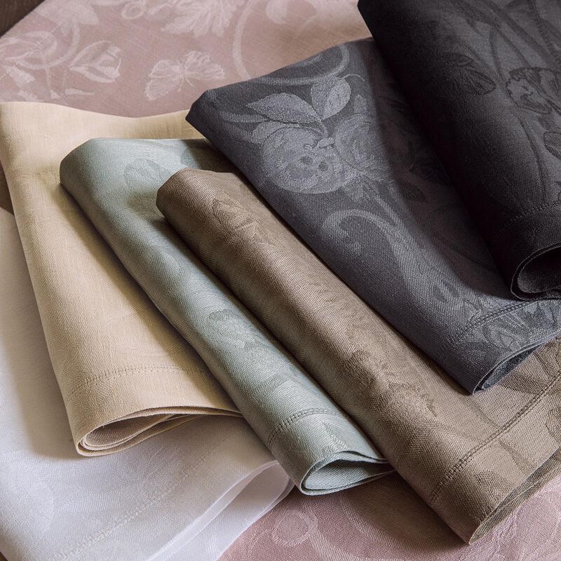 Le Jacquard Francais | Tivoli Napkin, White: Elegantly folded linen napkins featuring subtle floral patterns, showcasing superior European craftsmanship.