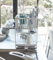 Yamazaki Home | Two-Tier Dish Rack, White, maximizes drying space with customizable tiers and utensil holder, perfect for organized, efficient kitchens.