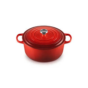Le Creuset | Round Dutch Ovens: Enameled cast-iron pot with lid, featuring loop handles and a stainless-steel knob, ideal for versatile cooking.