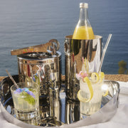 Christofle | Wine Cooler, Stainless Steel, elegantly set on a tray with cocktails, showcasing its modern design and versatility for stylish entertaining by the water.