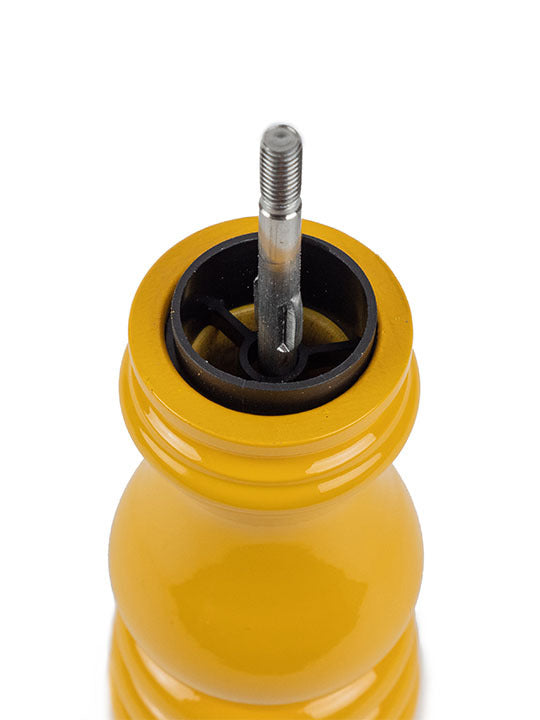 Peugeot | Paris U'Select Saffron Pepper Mill, 7 inches, showcasing the exposed grinding mechanism and central spindle within its vibrant yellow body.
