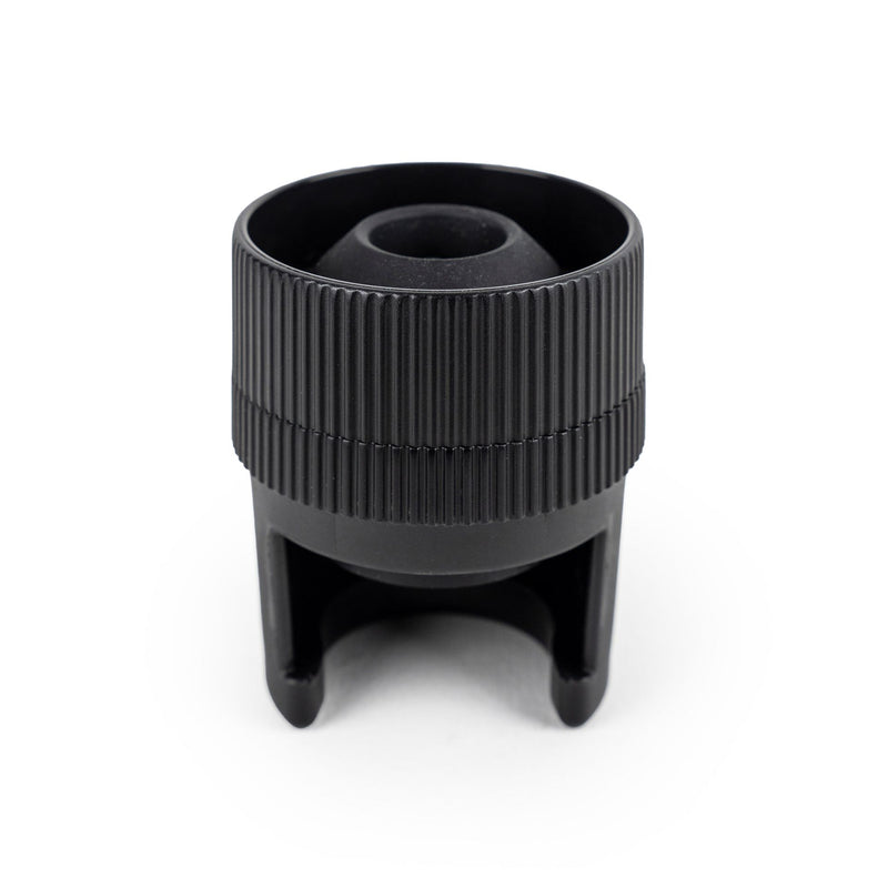 Peugeot Preserve Champagne Stopper, a sleek black object designed for sealing champagne bottles, ideal for preserving freshness.