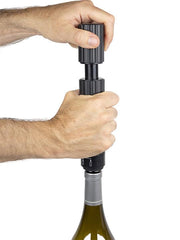 Person using the Peugeot | Preserve Duo - Black to open a wine bottle, showcasing its ergonomic design and functionality for wine enthusiasts.