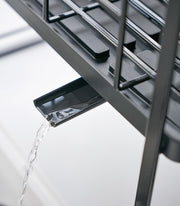 Yamazaki Home | Two-Tier Dish Rack features a spout directing water into the sink, maximizing drying space with its adjustable, removable tray and utensil holder.
