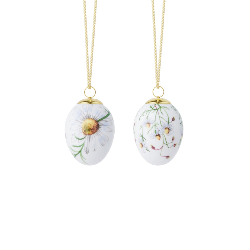 Royal Copenhagen | Spring 2026 Eggs Chamomile 6cm 2pc, featuring hand-painted daisy motifs on porcelain, suspended by gold cords, perfect for springtime decoration.