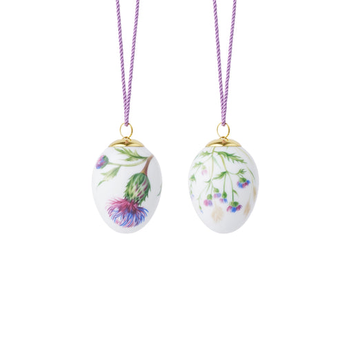 Royal Copenhagen Spring 2026 Eggs Thistle 6cm 2pc, featuring hand-decorated botanical designs on white porcelain, ideal as elegant spring-themed hanging decorations.