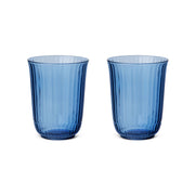 Royal Copenhagen | Waves Highball Glass, Blue, Set of 2 features translucent blue tumblers with flared shape and vertical ribbing, inspired by wave ripples.