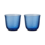 Royal Copenhagen | Waves Water Glass, Blue, Set of 2 features translucent ribbed tumblers, inspired by ocean ripples, ideal for any table setting.
