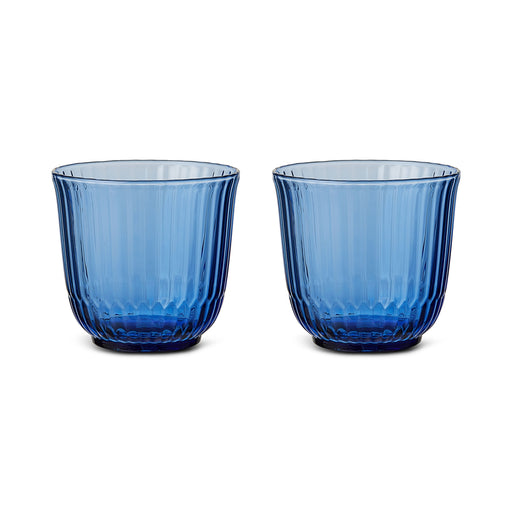Royal Copenhagen | Waves Water Glass, Blue, Set of 2 features translucent ribbed tumblers, inspired by ocean ripples, ideal for any table setting.