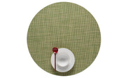 Chilewich | Mini Basketweave Round Placemat - Dill displayed beneath a white bowl and red spoon on a green mat, highlighting its refined texture and versatile design.