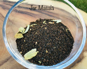 Jar Masala | Chai Teas - Spicy Tea: Close-up of aromatic spice and black tea blend, featuring peppercorns and star anise, handcrafted by a women-owned company.