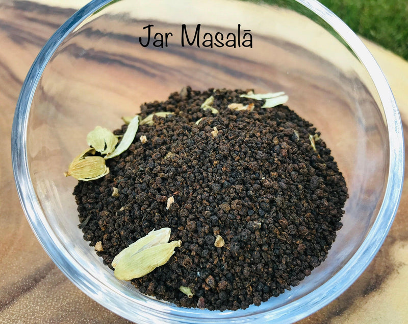 Jar Masala | Chai Teas - Spicy Tea: Close-up of aromatic spice and black tea blend, featuring peppercorns and star anise, handcrafted by a women-owned company.