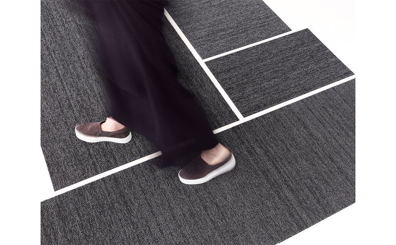 Chilewich Heathered Shag Mat in grey, 18x28, shown enhancing traction and texture underfoot, ideal for durable, stylish use in kitchens or entryways.