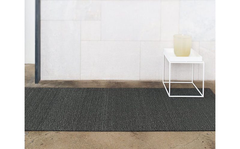 Chilewich Solid Shag Mat - Snow Runner 24 x 72 on display with a white table and bowl, showcasing its modern, versatile design.