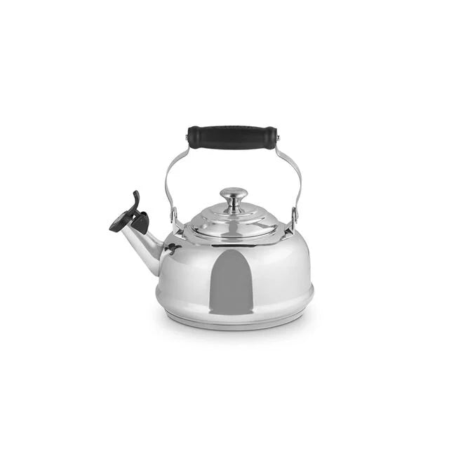 Le Creuset Classic Whistling Kettle, Stainless Steel, featuring a hinged black handle and spout cover, ideal for stovetop use, available at Athens Cooks kitchen store.