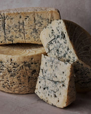 Sweet Grass Dairy | Asher Blue cheese: a group of blue mold cheeses showcasing its creamy-crumbly texture, ideal for gourmet cooking and cheese enthusiasts.