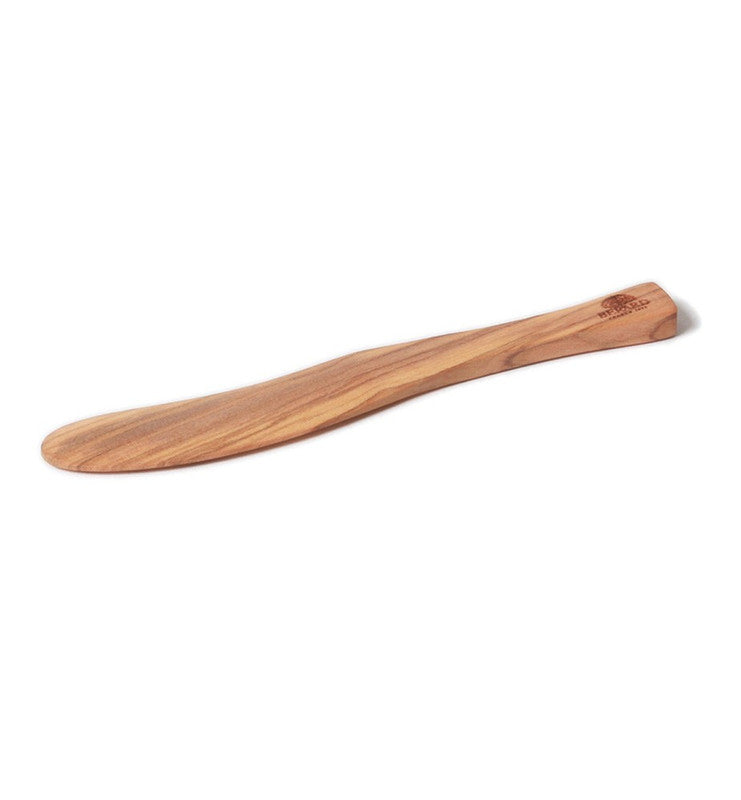 Berard Olivewood Spreader, 6-inch: A handcrafted, flat, paddle-shaped utensil ideal for spreading mustards, jams, or pestos, showcasing unique olive wood grain patterns.