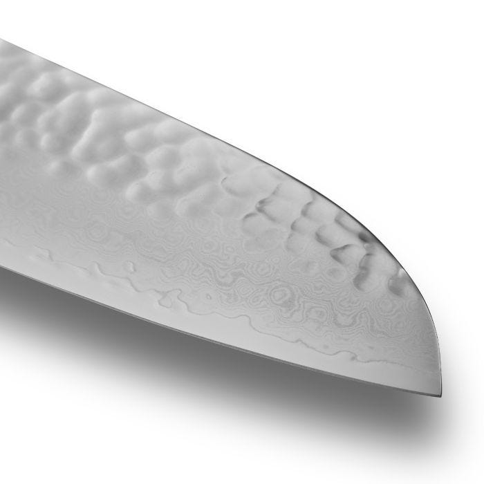 Close-up of Shun Premier Blonde Santoku 7 knife, showcasing its hammered tsuchime texture and elegant Damascus pattern, highlighting its craftsmanship and versatility for kitchen tasks.