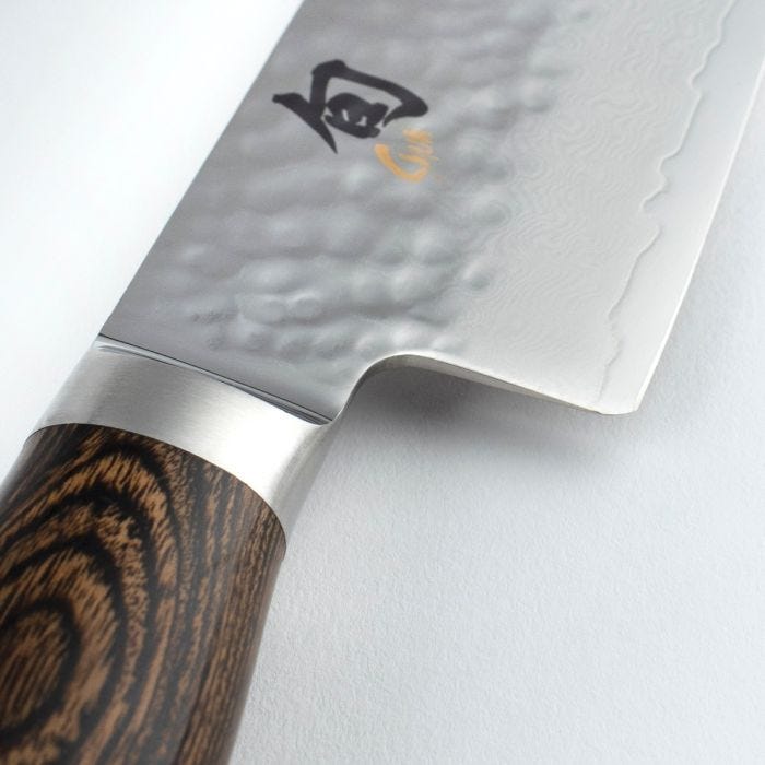 Shun Premier Chef's Walnut 8-inch knife with a hammered stainless-steel blade, Damascus pattern, and octagonal wooden handle, ideal for precise slicing and chopping.