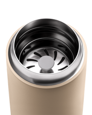 Close-up of FELLOW | Carter Move Mug, Sand Dune, 16 oz, highlighting the stainless steel rim and internal strainer, ideal for maintaining coffee flavor on the go.