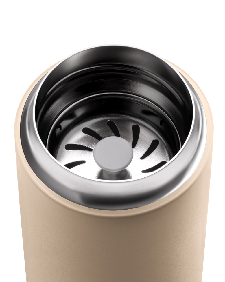 Close-up of FELLOW | Carter Move Mug, Sand Dune, 16 oz, highlighting the stainless steel rim and internal strainer, ideal for maintaining coffee flavor on the go.