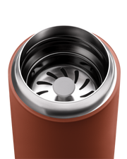 FELLOW | Carter Move Mug, Sienna / 16 oz, featuring a stainless-steel interior, orange exterior, and built-in strainer for tea or ice retention, ideal for travel.
