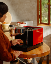 FELLOW | Espresso Series 1, Black, pulling a perfect espresso shot with precision on a compact machine in a sunlit kitchen, embodying professional home brewing.