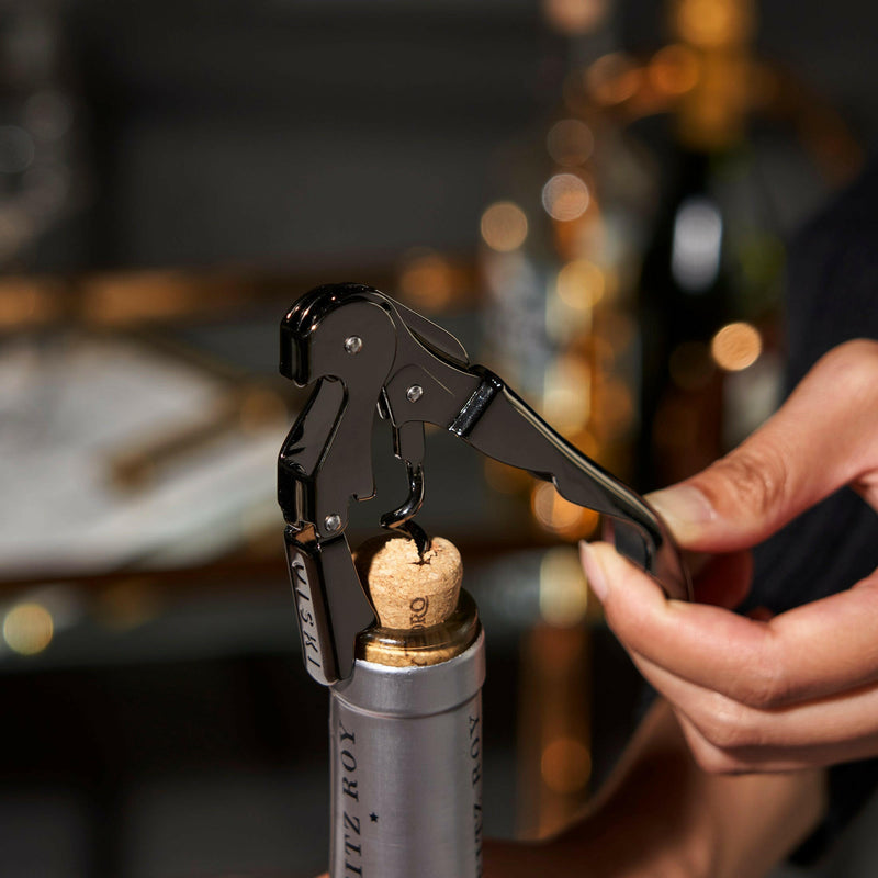Viski Warren Signature Waiter's Corkscrew in action, highlighting its double-hinged arm and integrated foil cutter, embodying top-shelf barware quality from Athens Cooks.