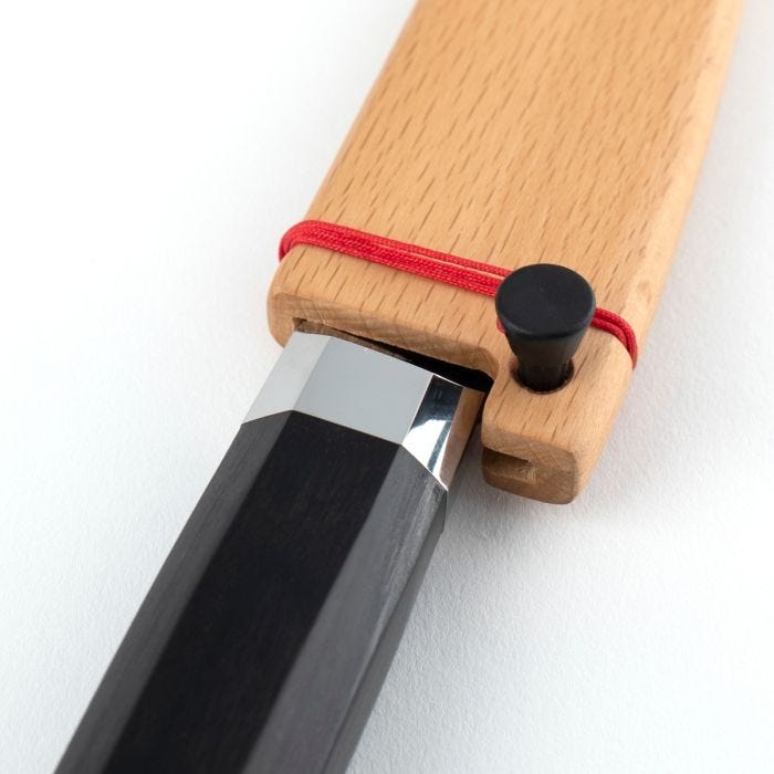 Shun | Dual Core Yanagiba, 10.5 inches, with polished metal collar in beech-wood sheath, features a red elastic cord and black octagonal handle.