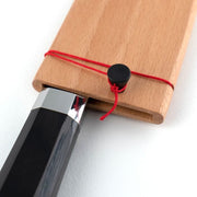 Shun Dual Core Santoku, 7 inches, features an octagonal handle in a wooden sheath, showcasing Japanese craftsmanship and versatility for kitchen tasks.