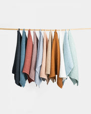 MagicLinen's large waffle kitchen towels in dusty blue, featuring a durable linen-cotton blend with a unique waffle weave for enhanced absorbency and quicker drying.