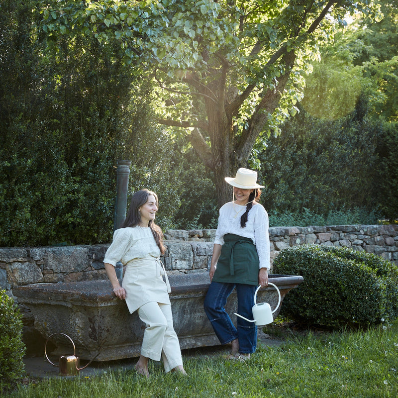 The Floral Society | Watering Can - White, features a modern design with a curved handle and extended spout, crafted from copper-plated stainless steel for durability.