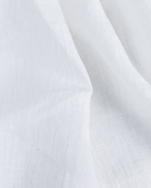 Elegant forest green linen tablecloth from MagicLinen, 59 x 98 inches, featuring a simple seam finish, perfect for various dining settings and occasions.