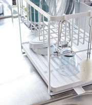 Yamazaki Home | Two-Tier Dish Rack, White: A space-saving, white metal rack with adjustable features, including a rotating spout and removable plastic tray, ideal for efficient dish drying.
