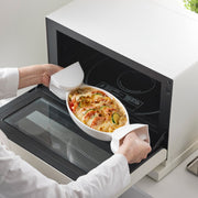 Yamazaki Home | Magnetic Pot Holders in action, effortlessly handling a hot vegetable gratin from a Balmuda oven, embodying practical elegance in kitchen tasks.