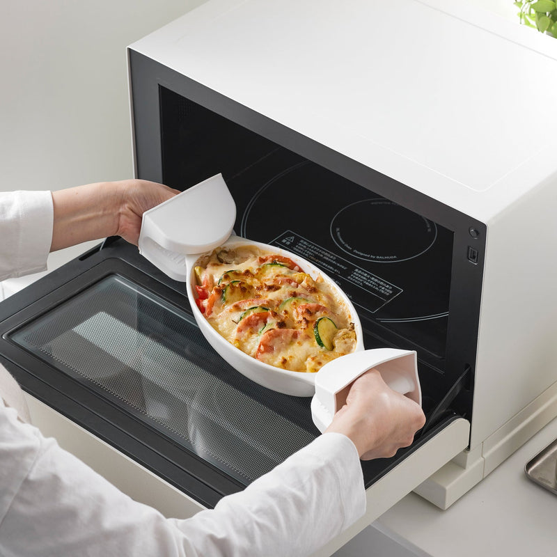 Yamazaki Home | Magnetic Pot Holders in action, effortlessly handling a hot vegetable gratin from a Balmuda oven, embodying practical elegance in kitchen tasks.