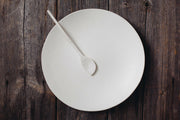 Looks Like White | Scandi Cereal Bowl: A minimalist, hand-painted white bowl by Trudy Crane, showcasing organic lines, on a dark wood surface.
