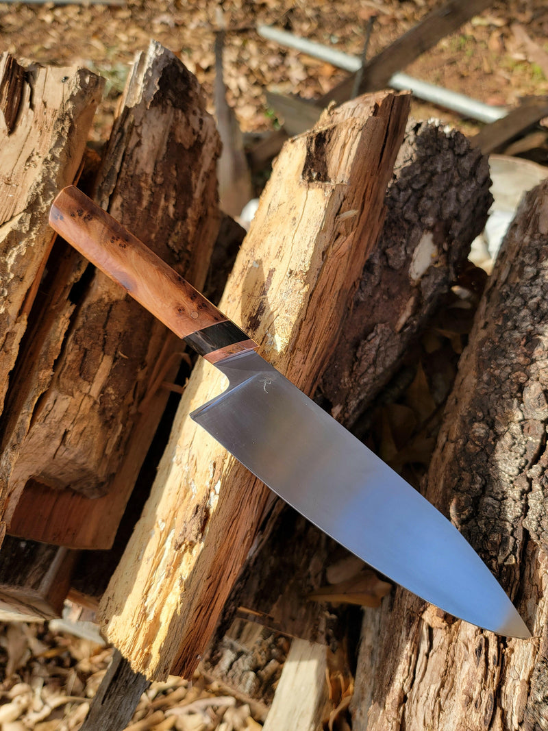 Rhymer Knives | 8 Chef Knives - African Blackwood + Rams Horn with Copper Bolster, hand-forged, displayed on a wooden surface, showcasing its precision-crafted blade and design.