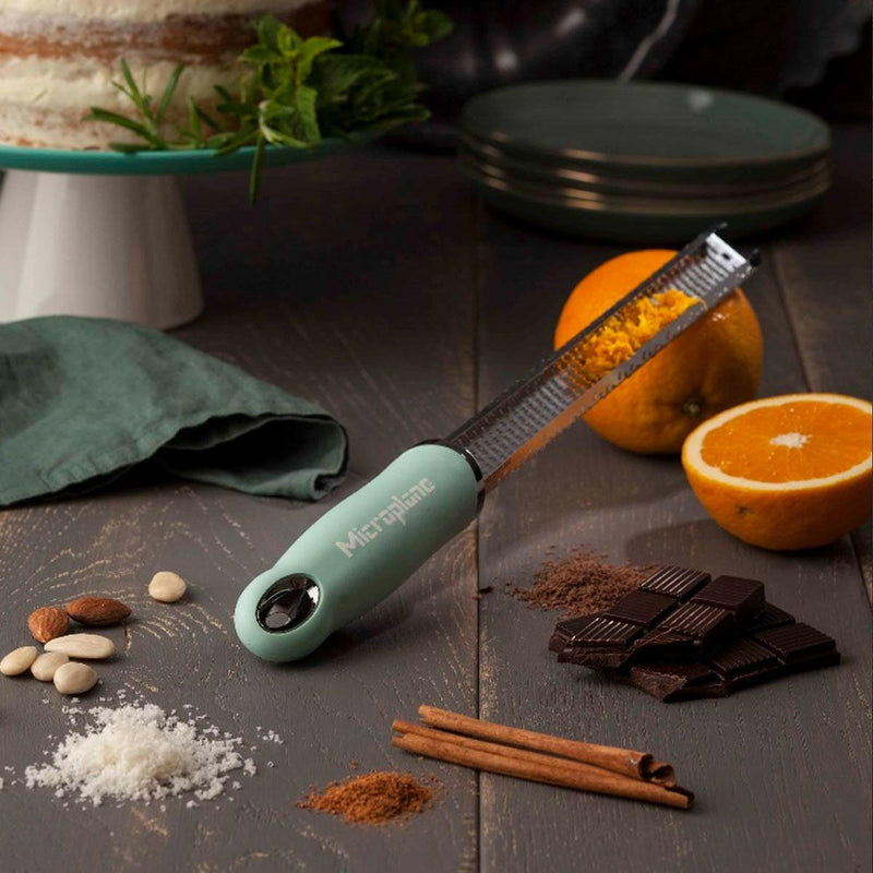 Microplane | Premium Zester, Grater - Classic Blue, surrounded by oranges, chocolate, nuts, and spices; ideal for zesting and enhancing culinary creations in Athens Cooks kitchen.