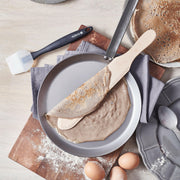 de Buyer | Mineral B Carbon Steel Crepe + Tortilla Pan - 10.25 showcased, highlighting its smooth, flat surface ideal for making crepes and tortillas, emphasizing its seasoned, natural non-stick properties.