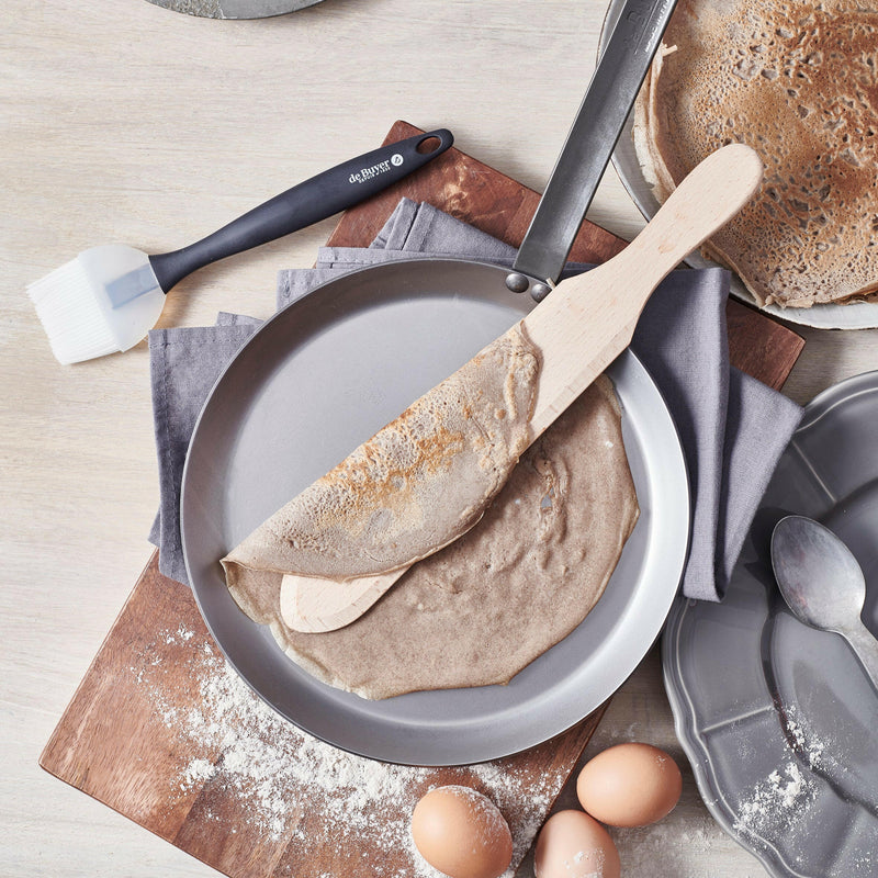 de Buyer | Mineral B Carbon Steel Crepe + Tortilla Pan - 10.25 showcased, highlighting its smooth, flat surface ideal for making crepes and tortillas, emphasizing its seasoned, natural non-stick properties.
