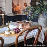 Ruffoni Symphonia Cupra Braisers - 7QT: A copper braiser with stainless steel handles and lid on a wooden surface, ideal for stovetop to oven cooking.