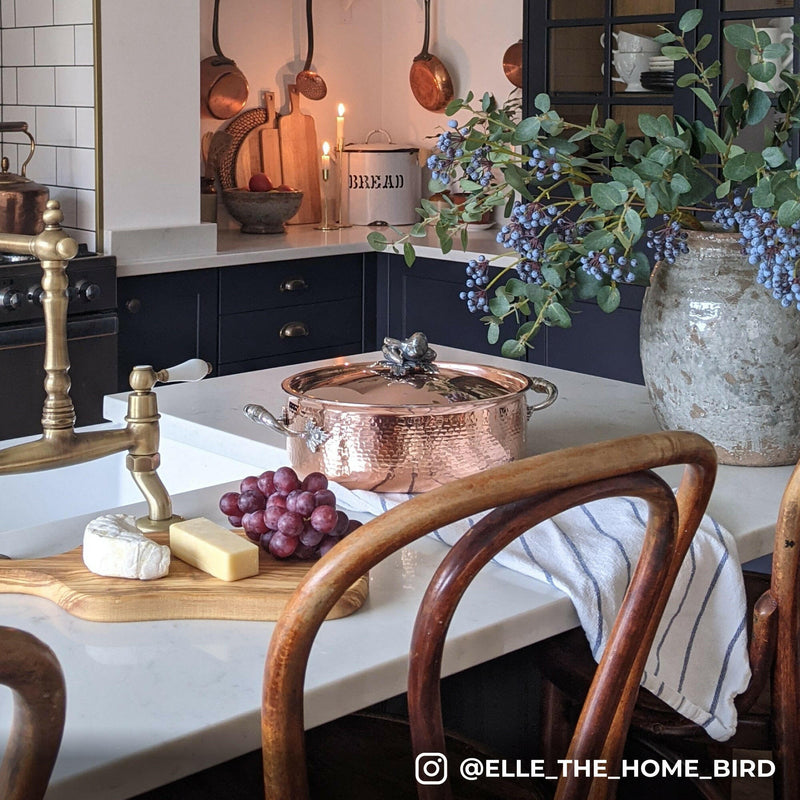 Ruffoni Symphonia Cupra Braisers - 7QT: A copper braiser with stainless steel handles and lid on a wooden surface, ideal for stovetop to oven cooking.