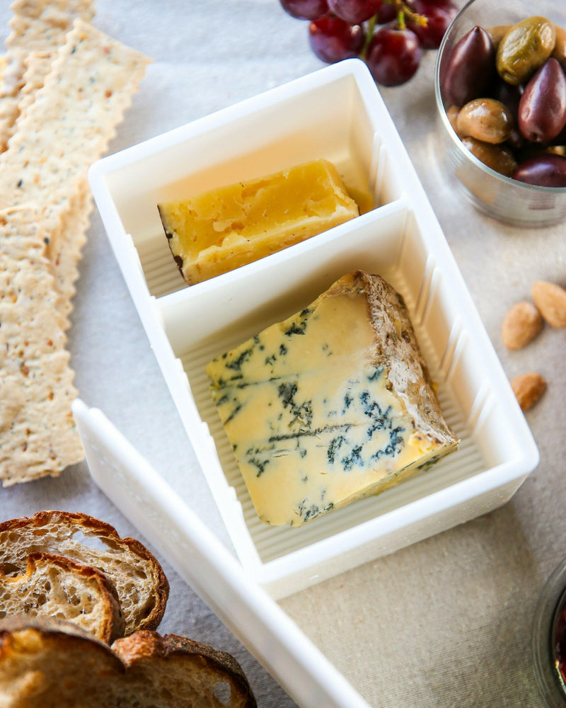 CapaBunga | Cheese Vaults - Soft Cheese - Biscuit (yellow) shown with cheese, grapes, and olives, highlighting its innovative storage solution for maintaining cheese freshness.
