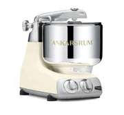 Ankarsrum | Stand Mixers in Store - Cloudy Pink: Cream-coloured heavy-duty mixer with stainless-steel bowl and dual knobs, ideal for versatile kitchen tasks.
