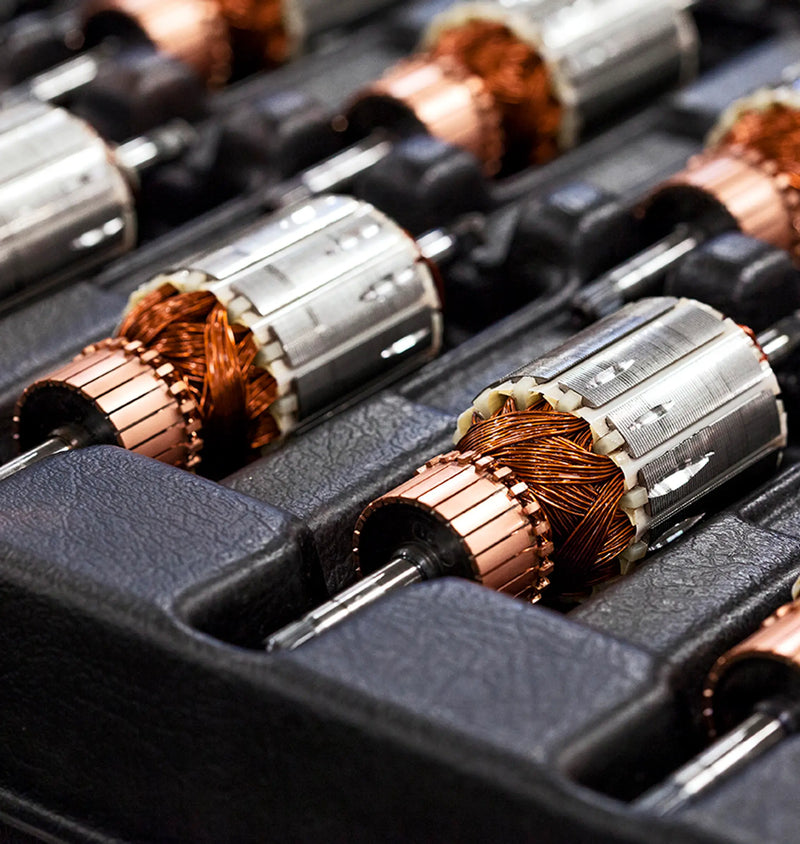 Set of electric-motor armatures in tray, showcasing Ankarsrum | Stand Mixers' powerful 1500 W motor at Athens Cooks, ideal for versatile kitchen tasks.