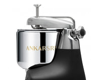 Ankarsrum | Stand Mixers in Store - Cloudy Pink: Sleek stainless-steel bowl and locking arm on a black base, showcasing the brand's robust design for versatile kitchen use.